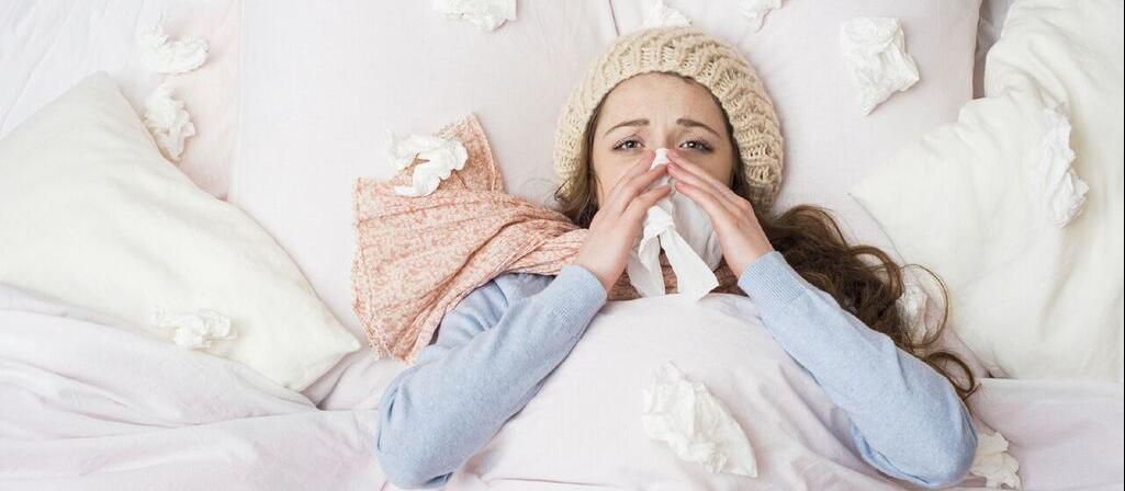 Woman blowing nose