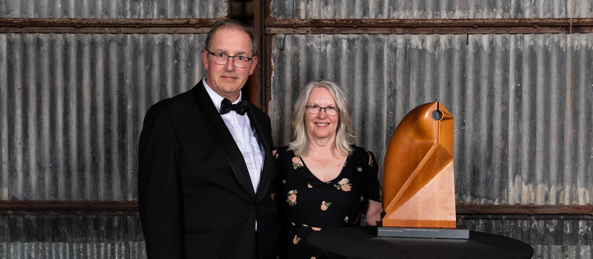 Adrian Tucker with his wife and the ACC Supreme award