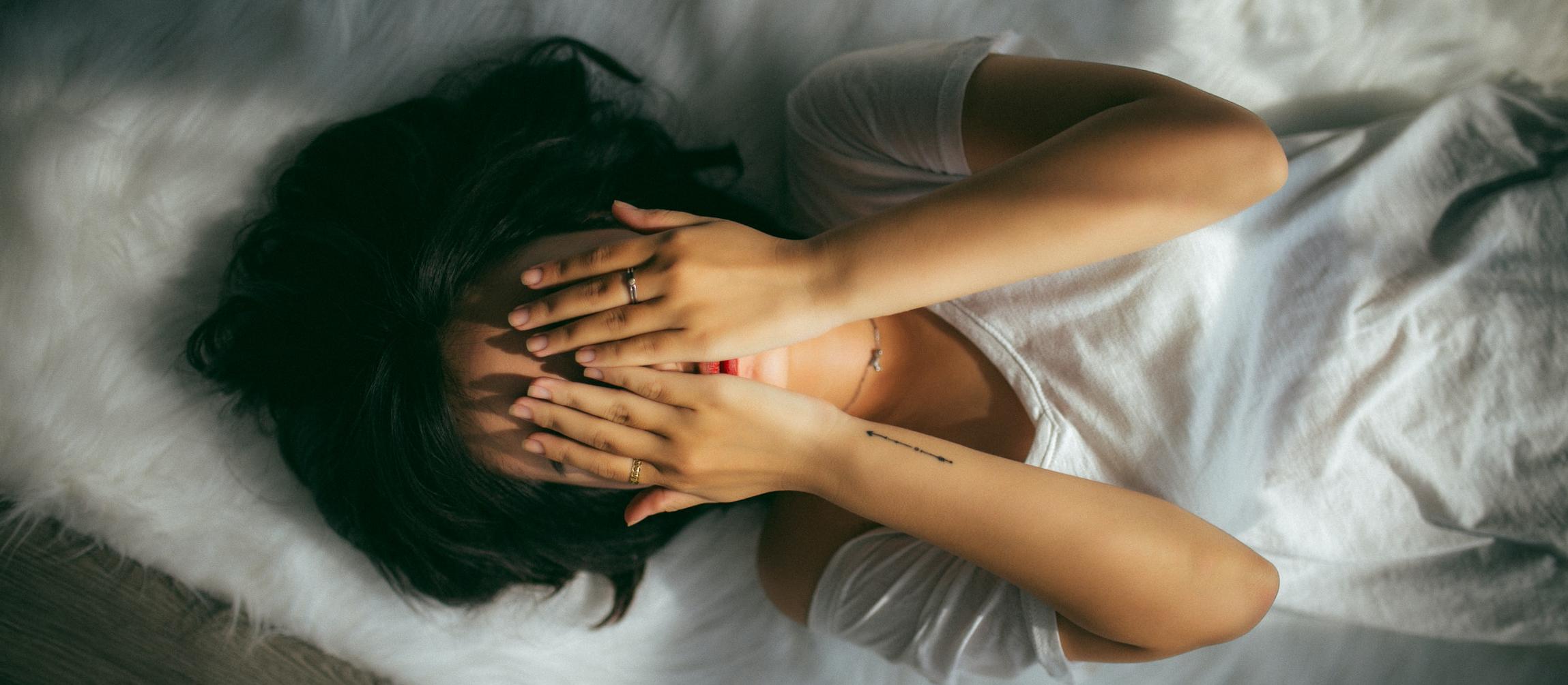 Embarrassed young woman covering face - unsplash.com 