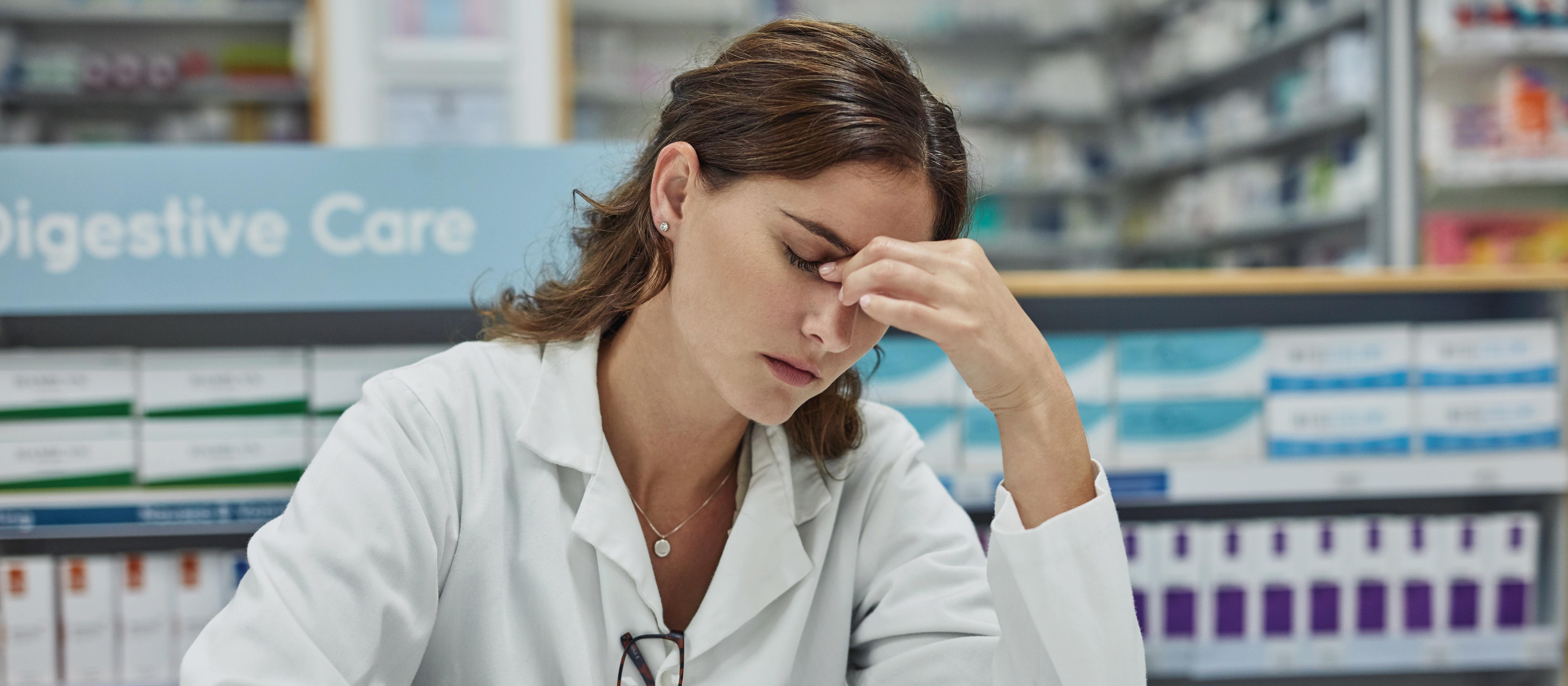 Stressed with headache pharmacist 