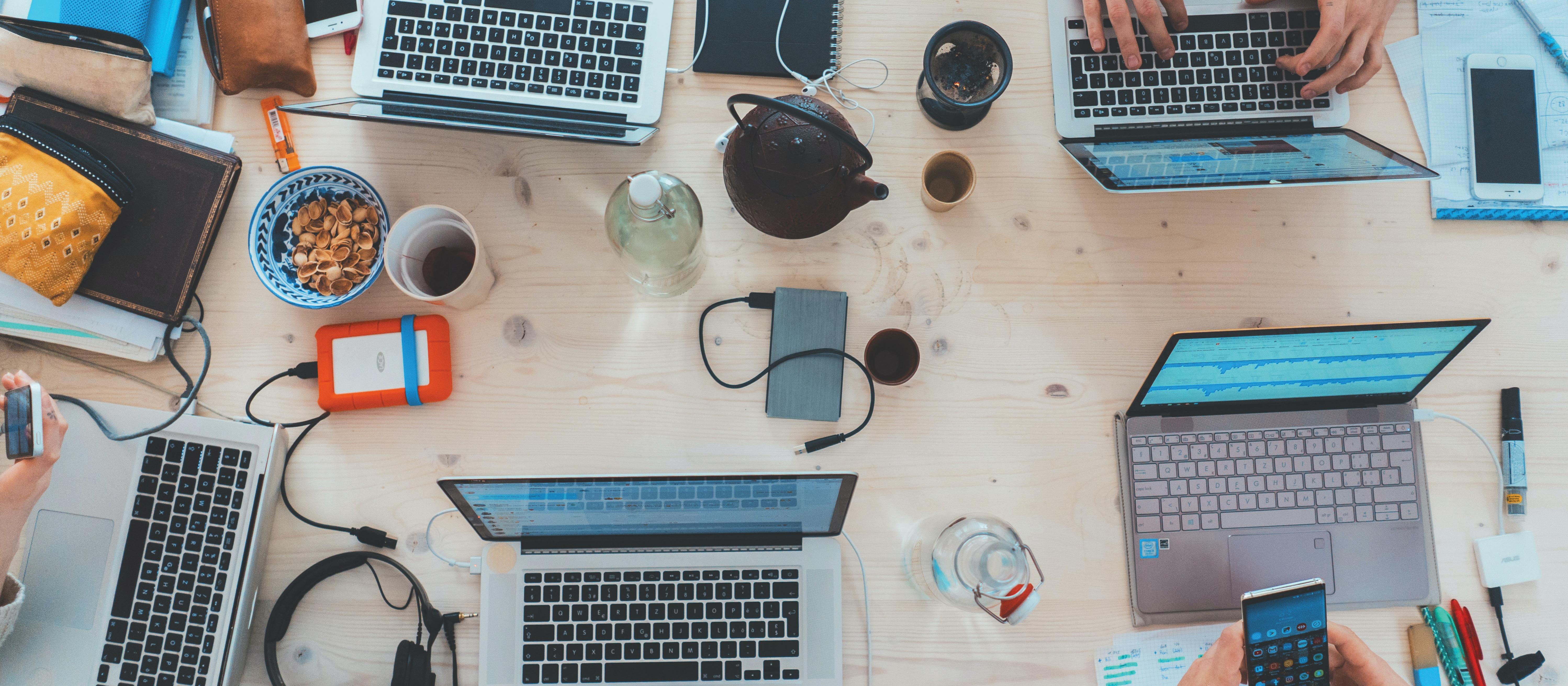 Top view of study group working on desk. Photo: Marvin Meyer on Unsplash