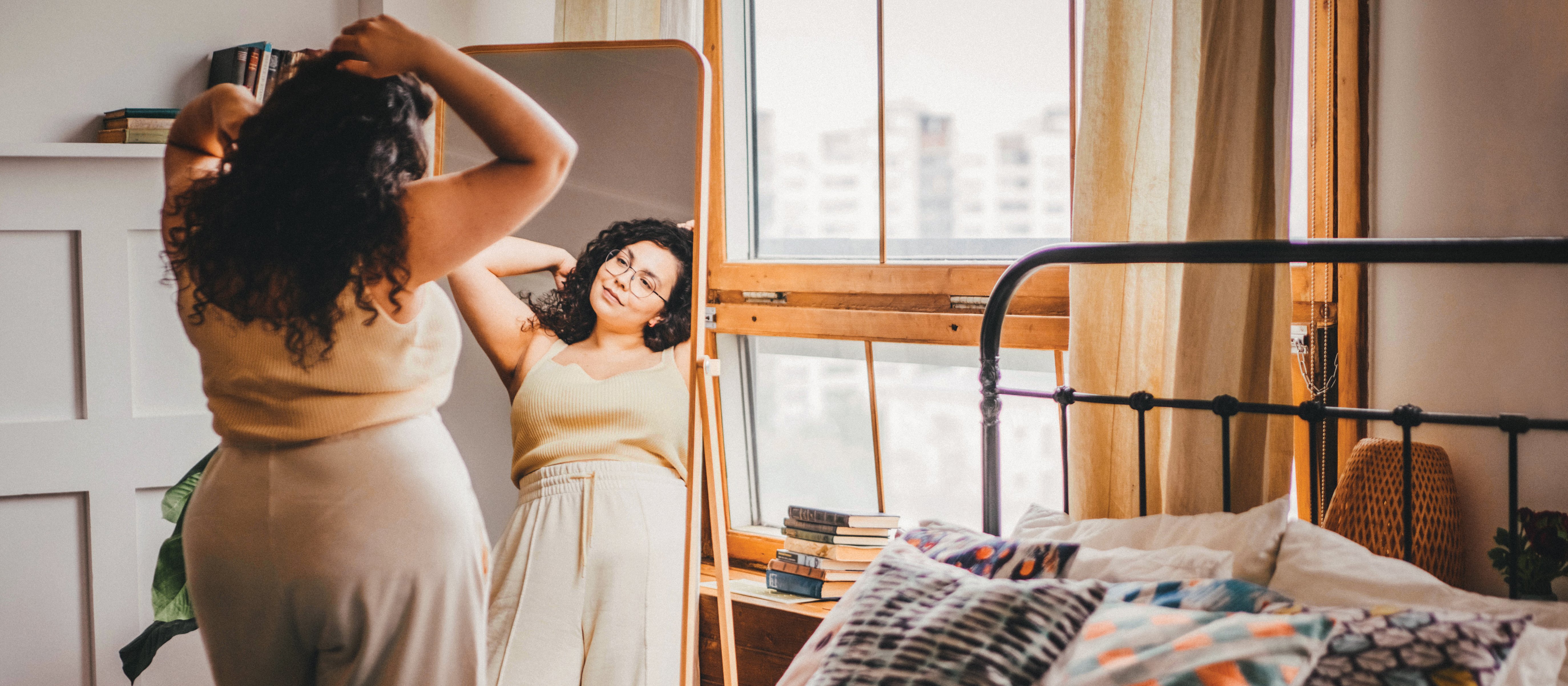 Young woman looking in mirror