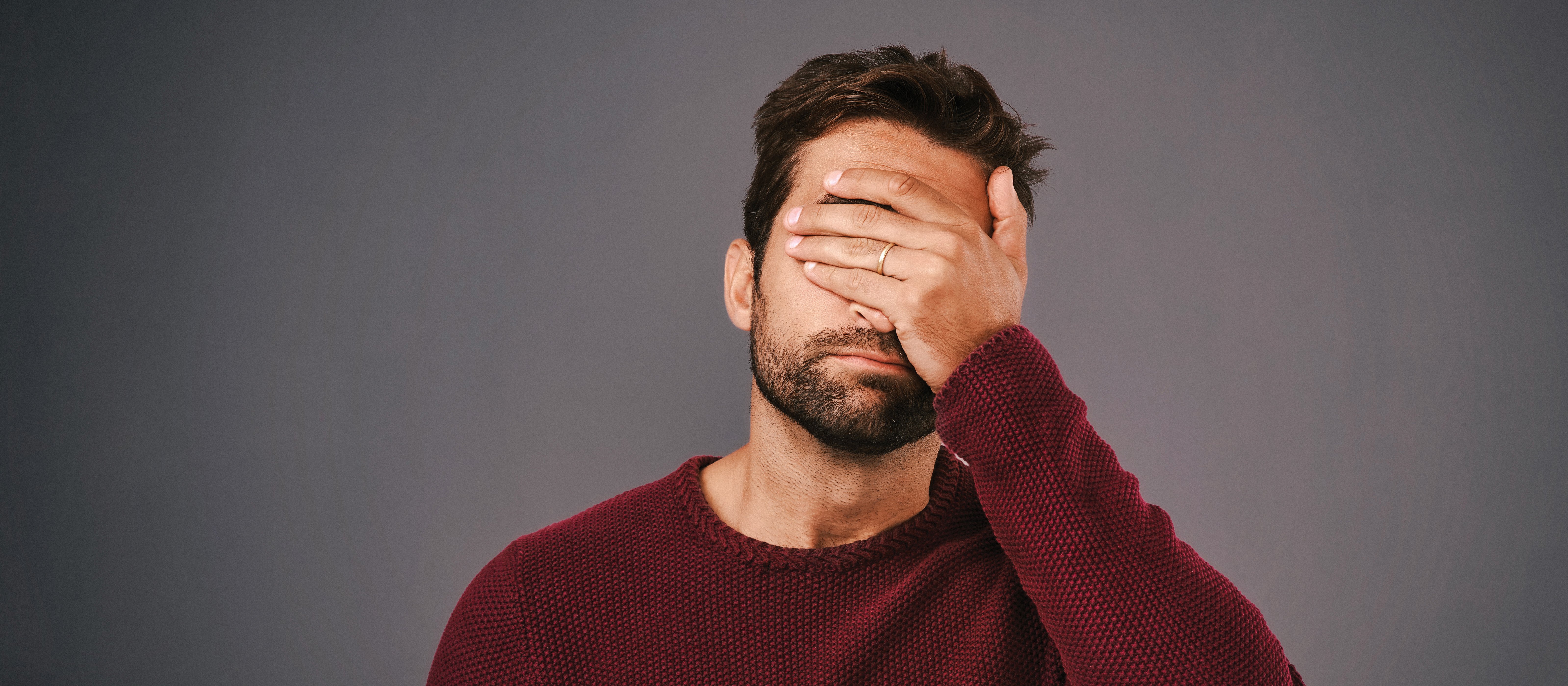 Man with hand over face