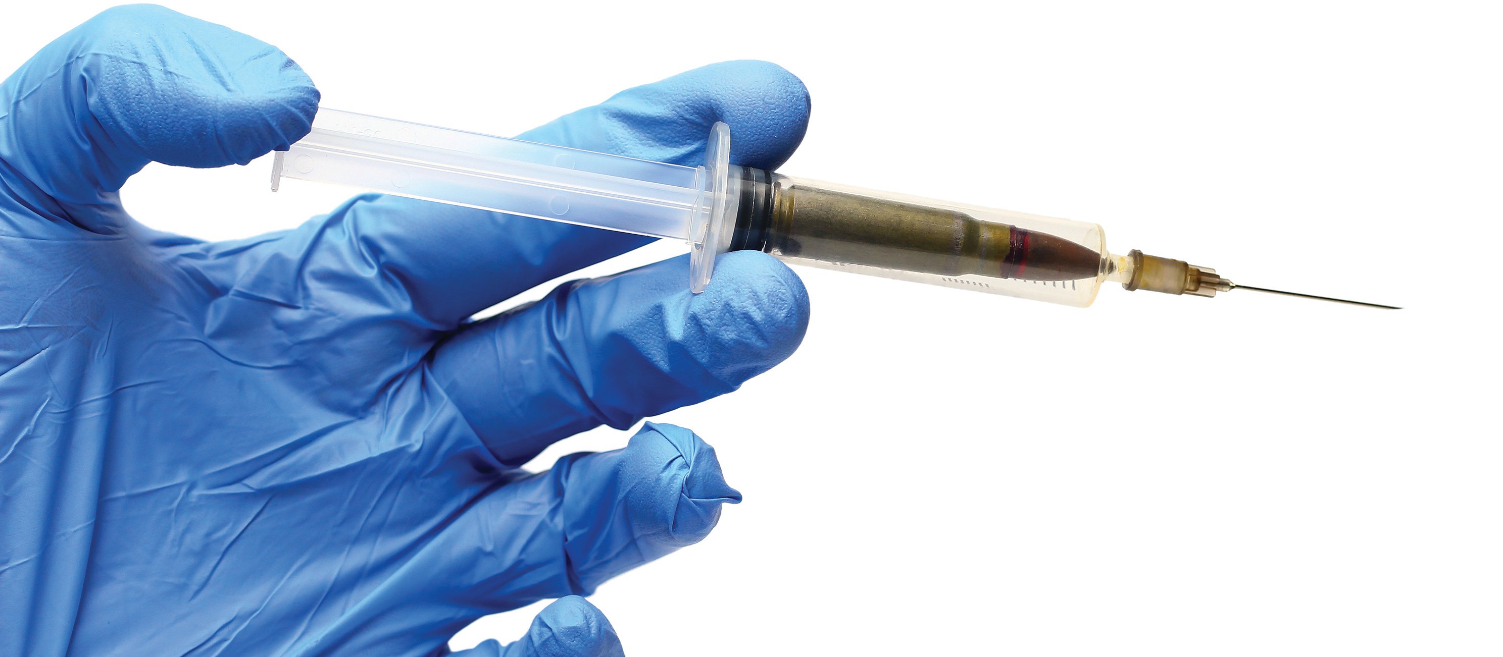 Hand holding syringe