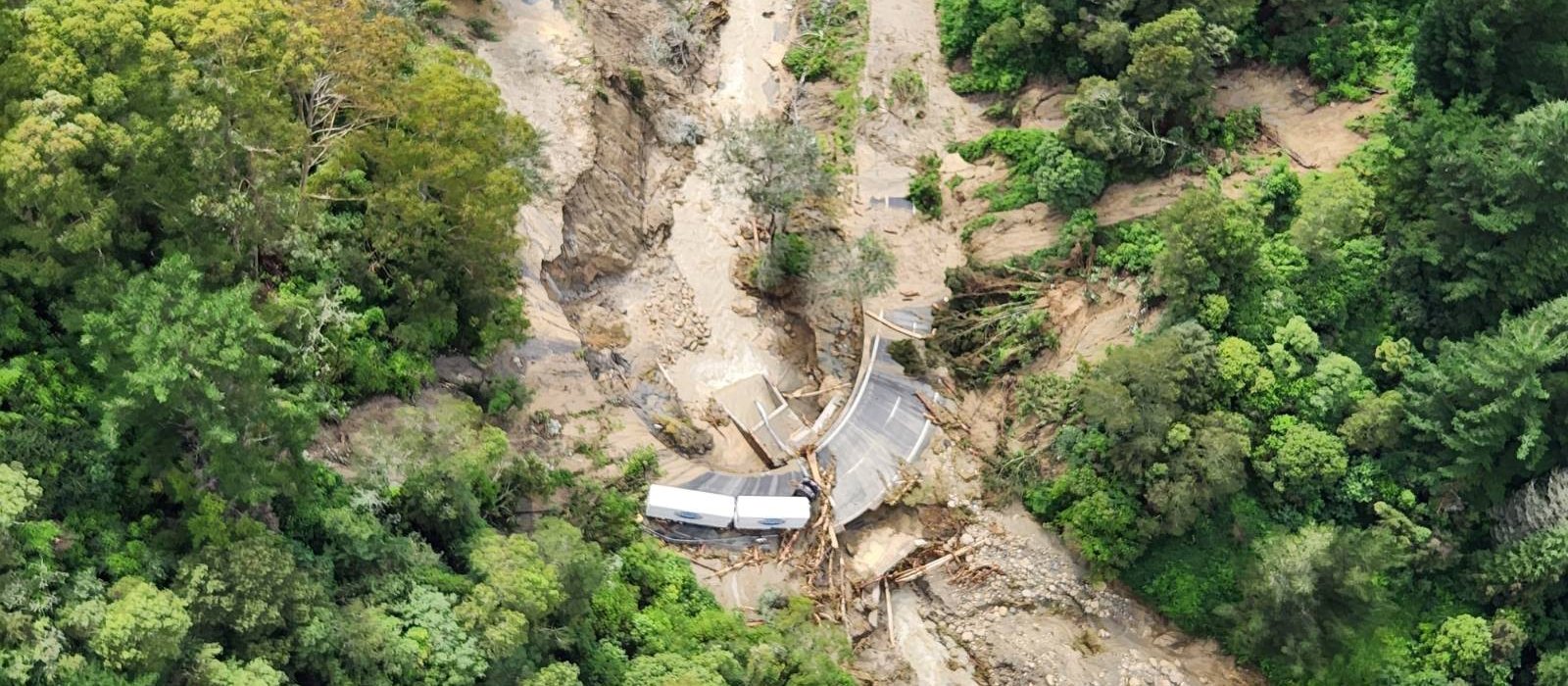 TRUCK TRAPPED BY FLOODING ON WASHED OUT SH2 BETWEEN NAPIER AND WAIROA, TAKEN BY NZDF NH90 CHOPPER [IMAGE: NZDF] 