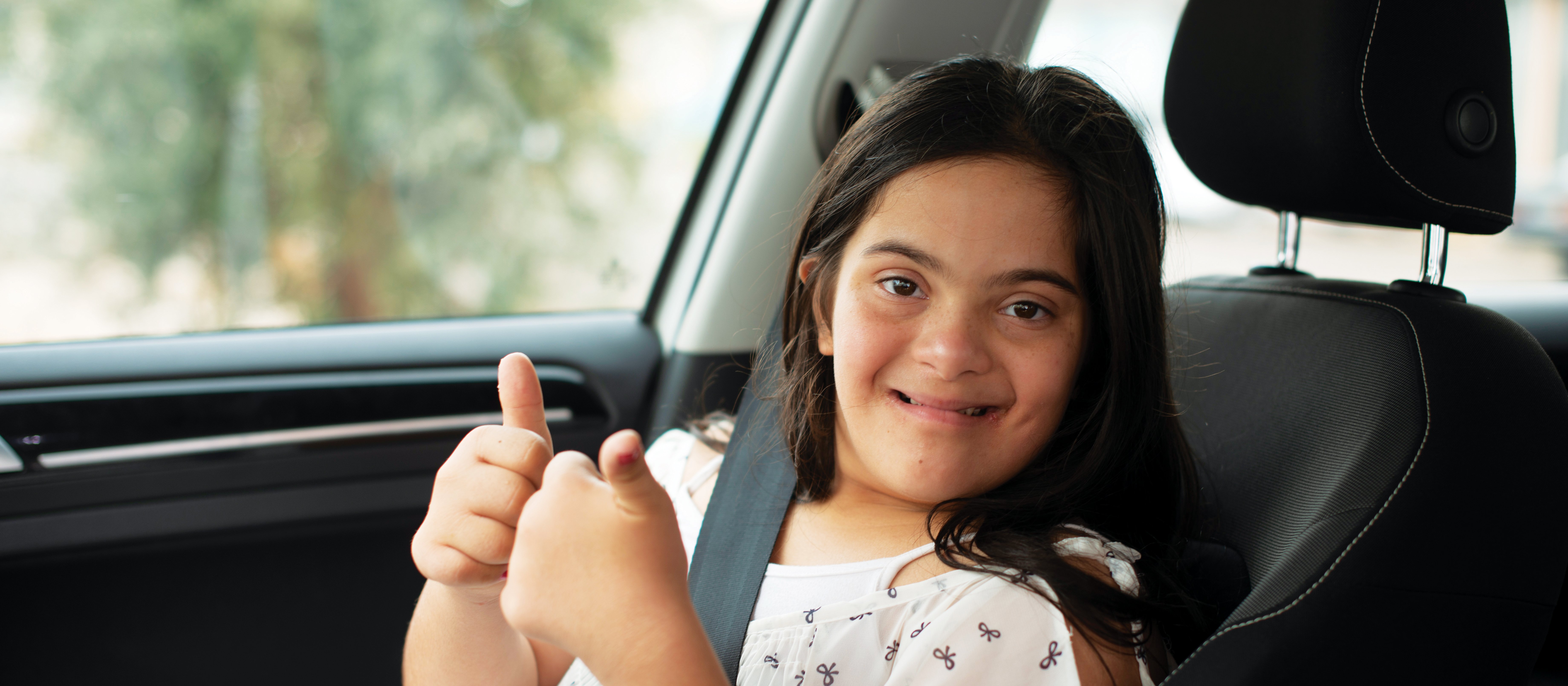 Down syndrome girl in car