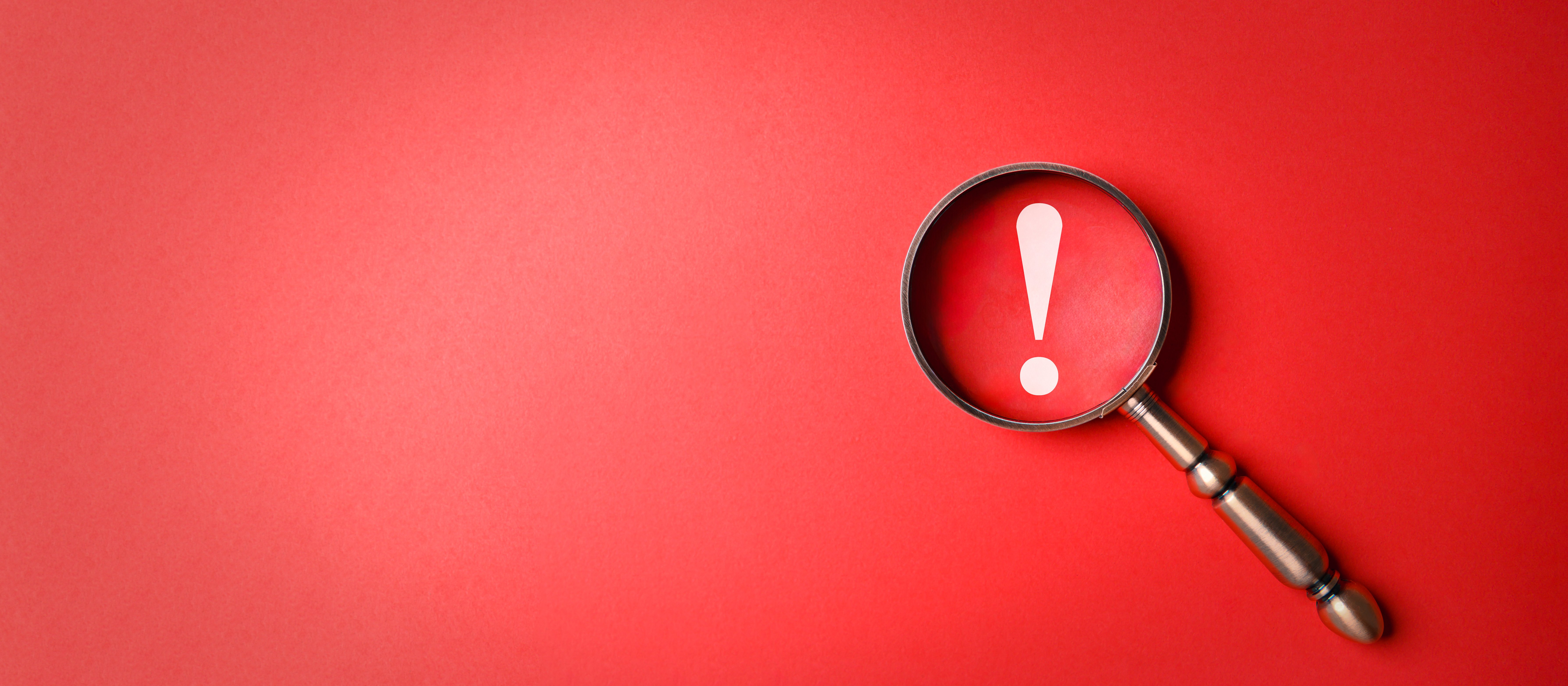 Exclamation mark magnifying glass