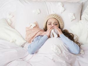 Woman blowing nose