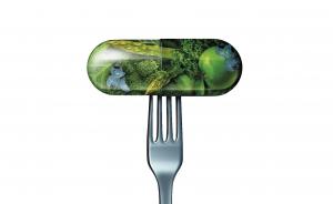 Green pill on a fork
