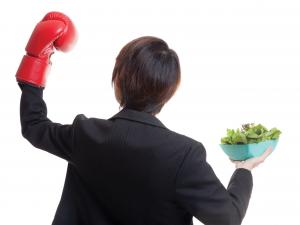 Woman boxing while holding salad
