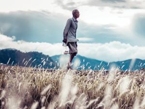 Elderly asian man walking along. unsplash.com
