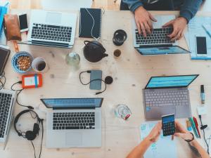Top view of study group working on desk. Photo: Marvin Meyer on Unsplash