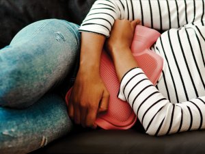 Women with hot water bottle