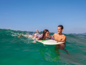 Father and daughter surfing