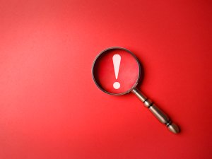 Exclamation mark magnifying glass