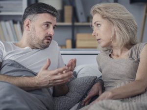 Couple talking in bed