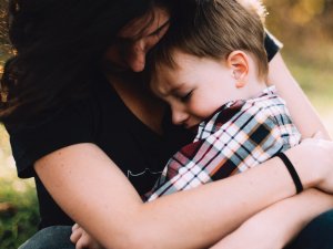Woman hugs child CR Jordan Whitt on Unsplash